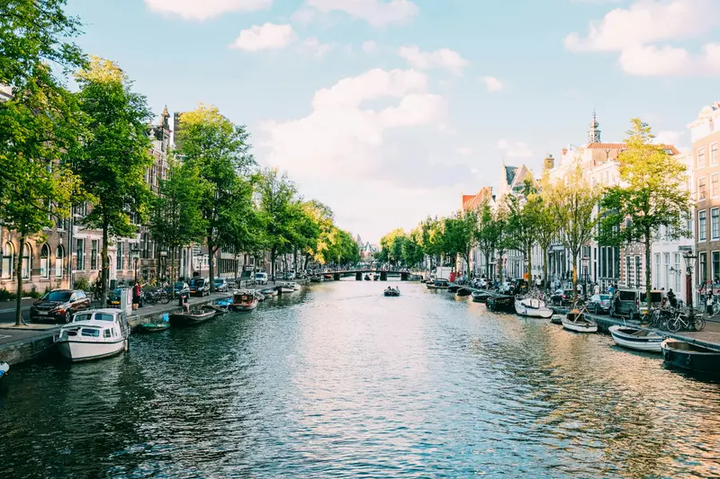 Boats on a tree-lined canal in Amsterdam