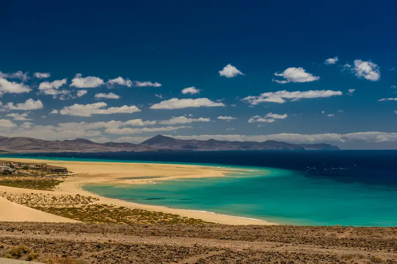 A long sandy beach and turquoise lagoon in Fuerteventura