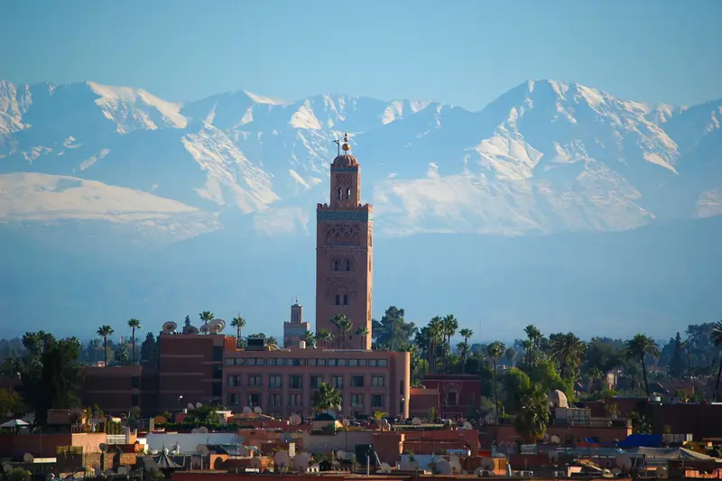 The Koutoubia minaret in Marrakech with the snowy Atlas Mountains behind