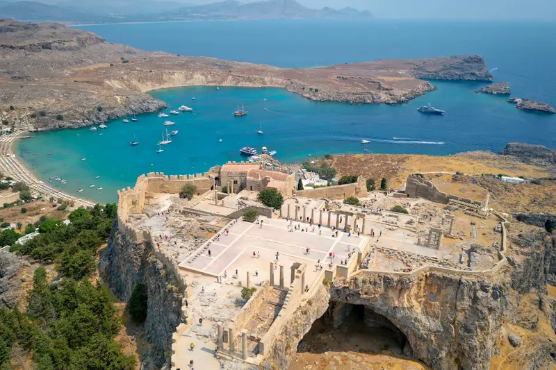 The acropolis of Lindos above a blue bay on Rhodes