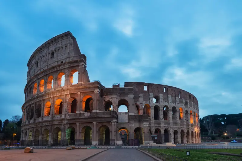 The Colosseum in Rome under a blue sky