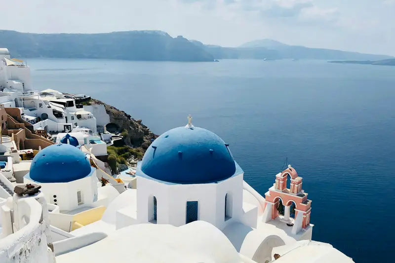 Blue-domed white churches above the sea in Santorini