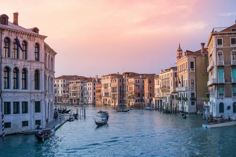 Gondolas and palazzos on the Grand Canal in Venice at dusk