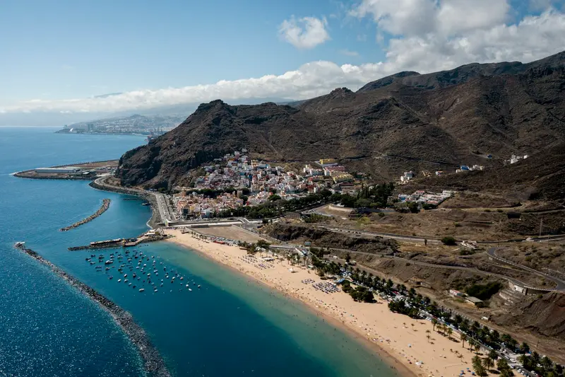 Las Teresitas beach in Tenerife with mountains behind and calm blue sea